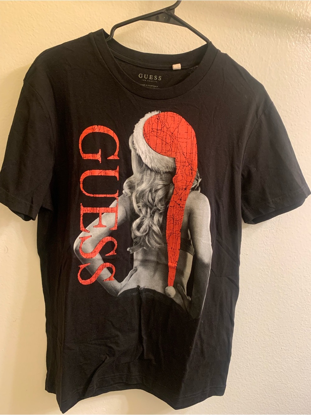 GUESS Black Graphic Tee with Red Santa Hat Accent